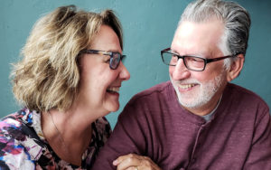 woman laughing at grey haired man