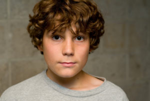 preteen boy with curly hair