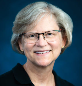 headshot of woman with white hair