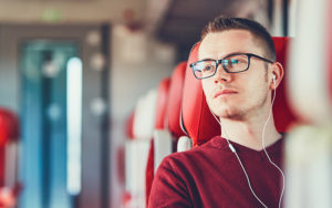 man on train wearing headphones
