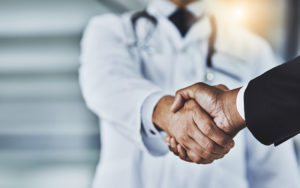 man shaking hands with doctor